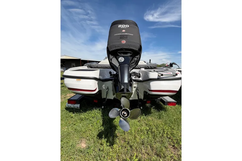 Slide: The Image of 2018 Nitro Z19 Sport boat with powerful outboard motor on grassy field. - 11