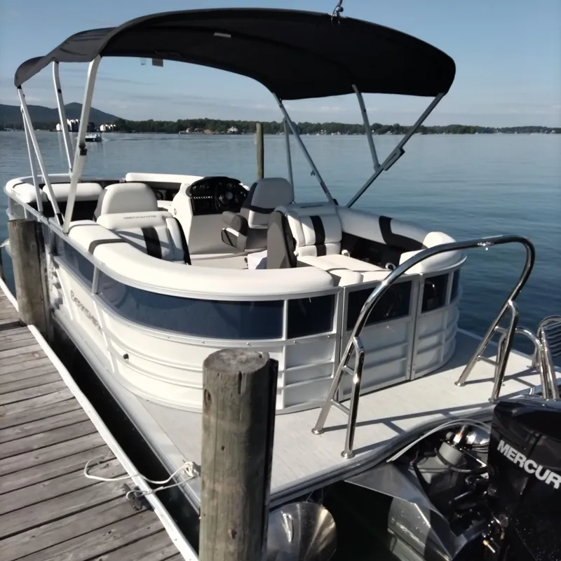 Slide: The Image of 2024 Berkshire 22RFX CTS 3.0 Performance pontoon boat docked on a serene lake. - 2