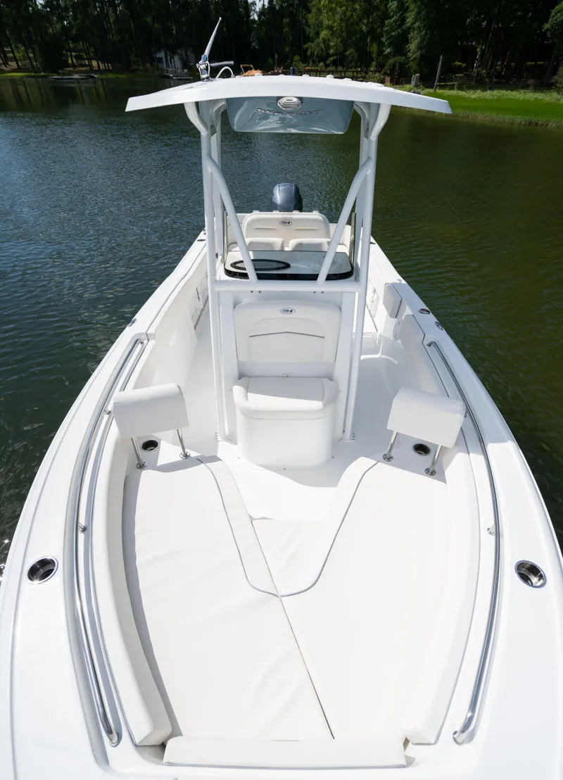 Slide: The Image of 2024 Sea Hunt Ultra 234 boat on calm water. - 11
