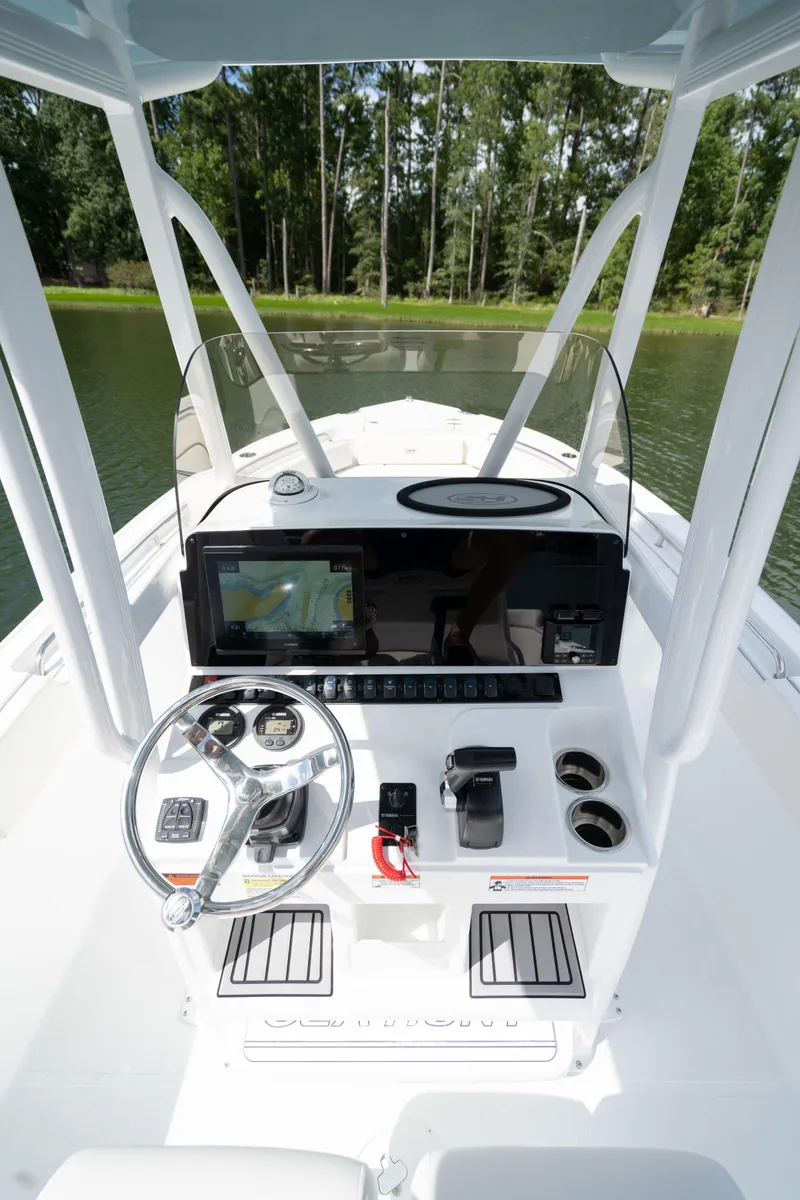 Slide: The Image of 2024 Sea Hunt Ultra 234 boat console with steering wheel and navigation system. - 12