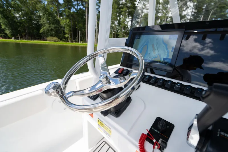 Slide: The Image of 2024 Sea Hunt Ultra 234 boat helm with navigation system. - 14
