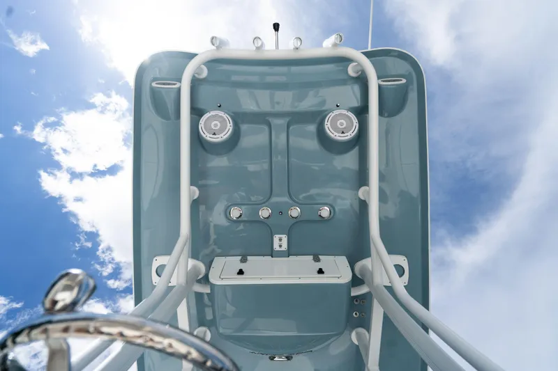 Slide: The Image of 2024 Sea Hunt Ultra 234 boat console against a blue sky. - 20