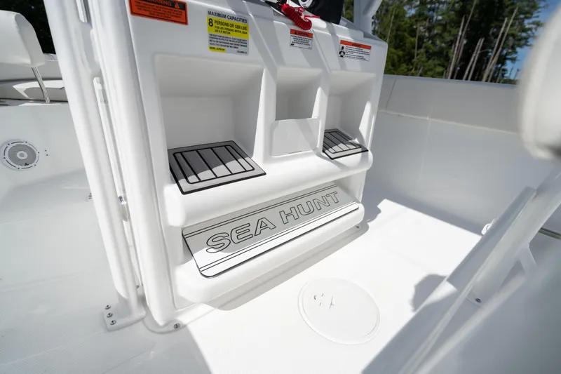 Slide: The Image of 2024 Sea Hunt Ultra 234 boat interior with branded step and storage compartments. - 21