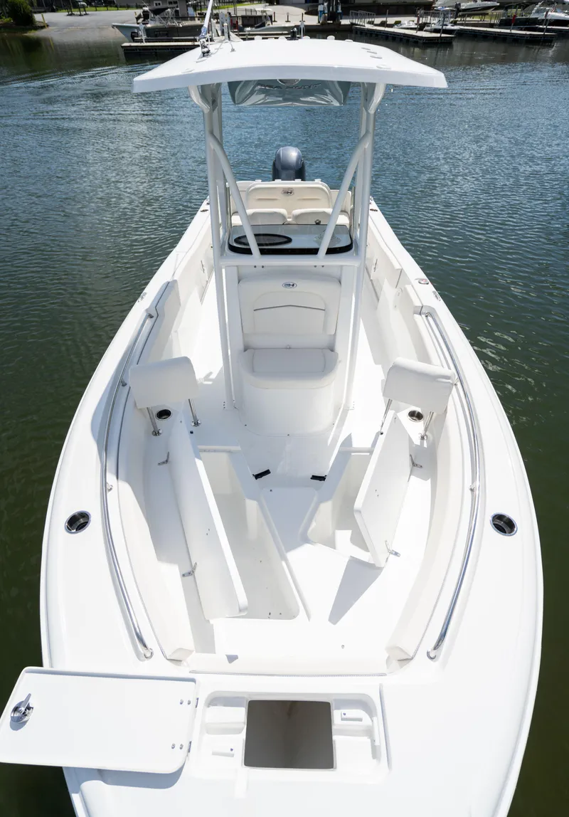 Slide: The Image of 2024 Sea Hunt Ultra 234 boat on water, showcasing spacious deck and seating. - 23