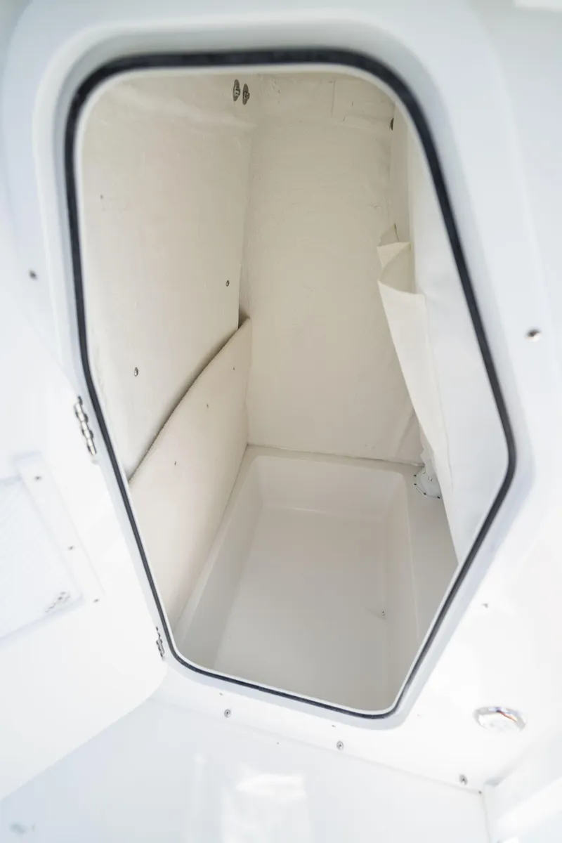 Slide: The Image of 2024 Sea Hunt Ultra 234 storage compartment interior view. - 25
