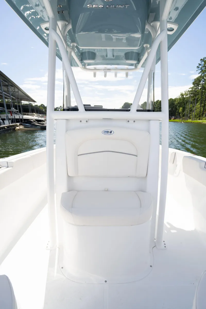 Slide: The Image of 2024 Sea Hunt Ultra 234 boat interior with white seating and console. - 26