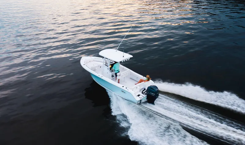 Slide: The Image of 2024 Sea Hunt Ultra 234 boat cruising on open water. - 3