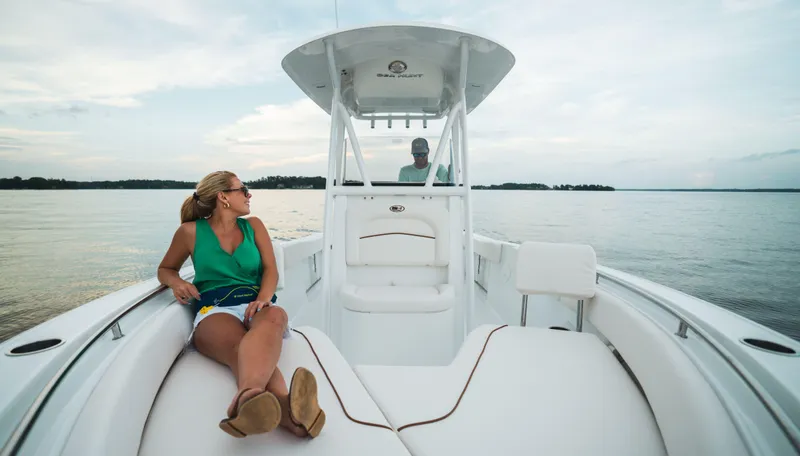 Slide: The Image of 2024 Sea Hunt Ultra 234 boat with passengers enjoying the water. - 6