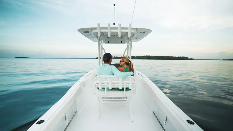 Slide: The Image of Couple enjoying a serene ride on a 2024 Sea Hunt Ultra 234 boat. - 7