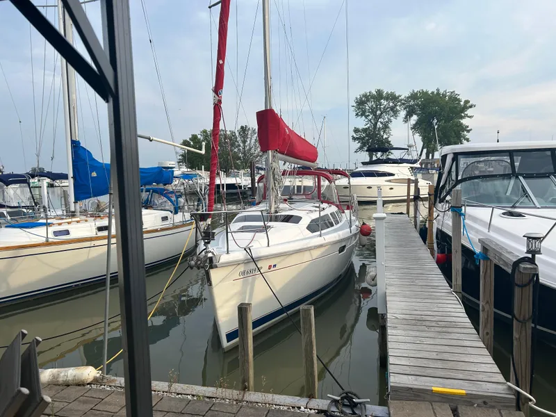 The Image of Sailboat docked at marina, Hunter 336 model, 1996, with red sail cover. - 0