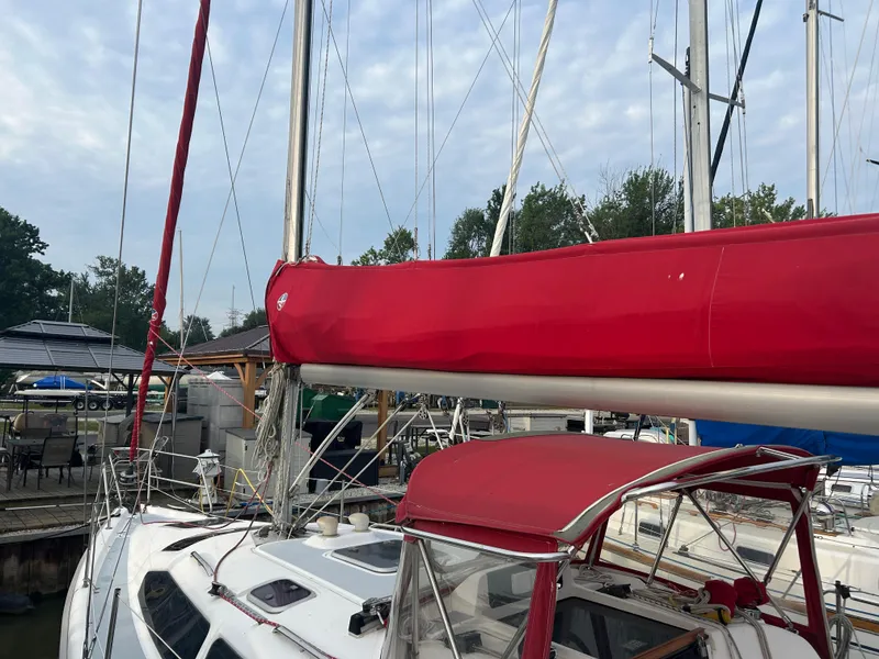 Slide: The Image of Sailboat Hunter 336, 1996 model, docked with red sail cover and canopy. - 13