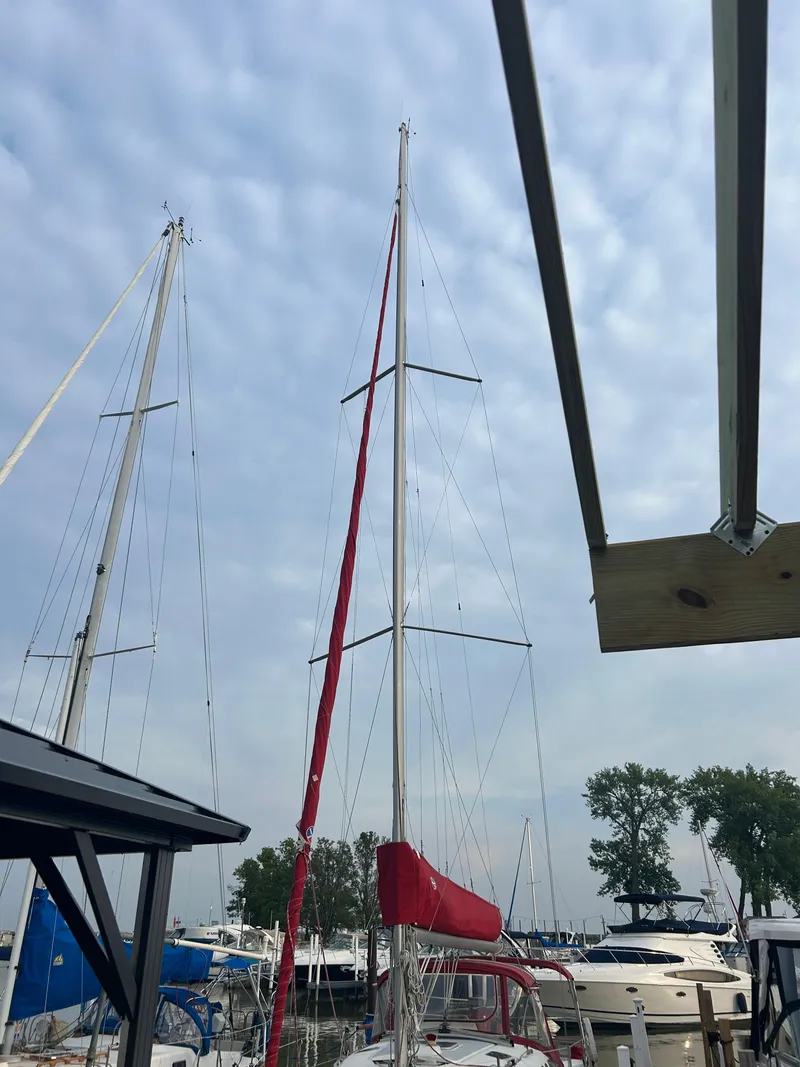 Slide: The Image of Sailboats docked at marina under cloudy sky, featuring a 1996 Hunter 336. - 14