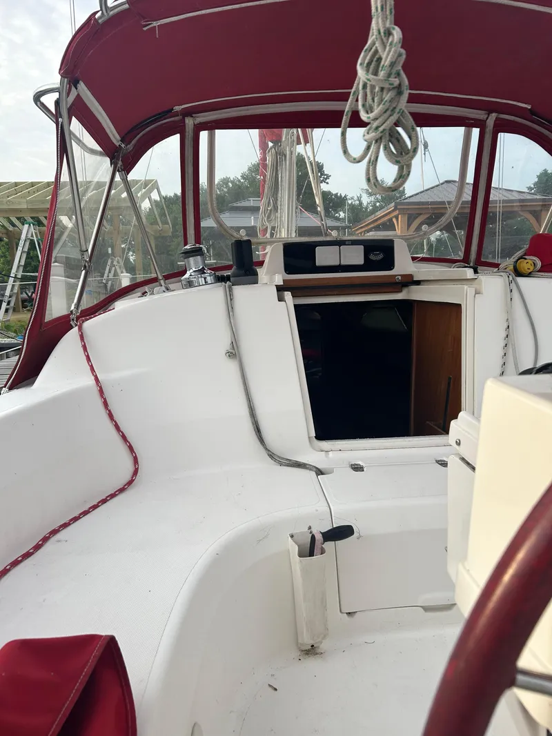 Slide: The Image of Interior view of a 1996 Hunter 336 sailboat cockpit with red canopy. - 18