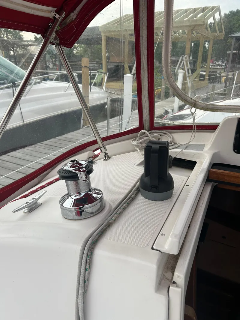 Slide: The Image of Interior view of a 1996 Hunter 336 sailboat cockpit with winch and red canopy. - 19