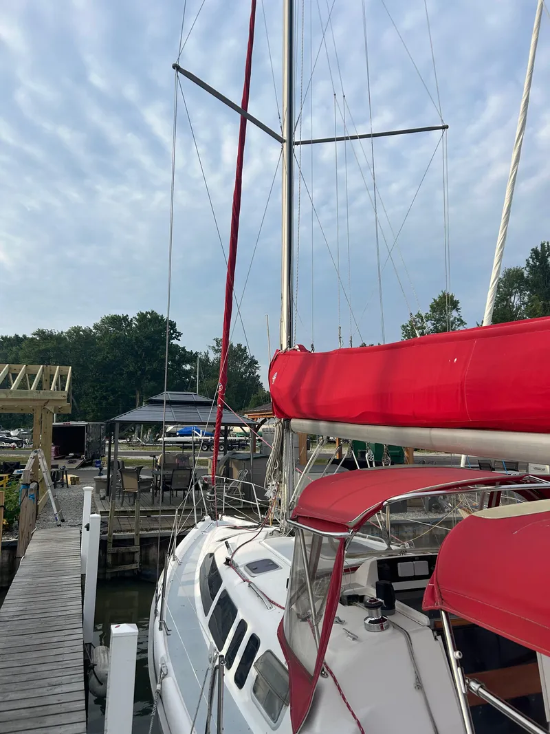 Slide: The Image of Sailboat docked at marina, Hunter 336 model, 1996, with red sail cover and canopy. - 2