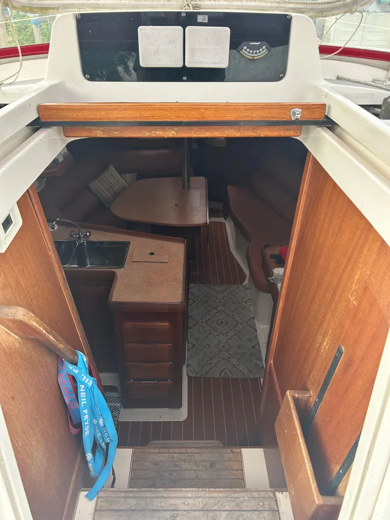 Slide: The Image of Interior view of a 1996 Hunter 336 sailboat cabin with wood finish and compact kitchen. - 22