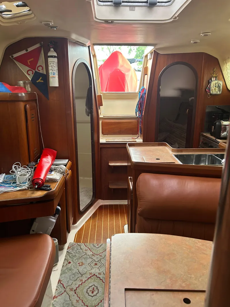 Slide: The Image of Interior of a 1996 Hunter 336 sailboat with wood finish and nautical decor. - 23