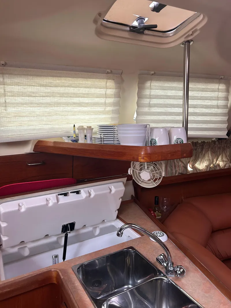 Slide: The Image of Interior of 1996 Hunter 336 sailboat with kitchen sink and dining area. - 25