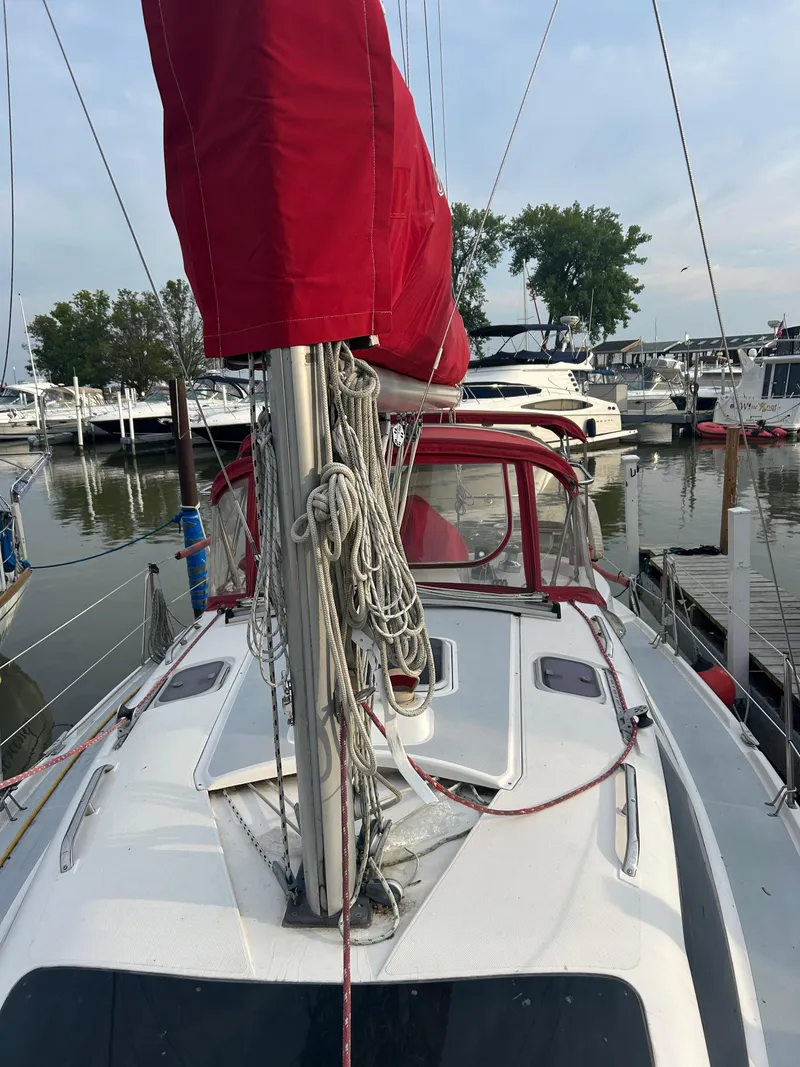 Slide: The Image of Sailboat Hunter 336, 1996 model, docked with red sail cover, marina background. - 3