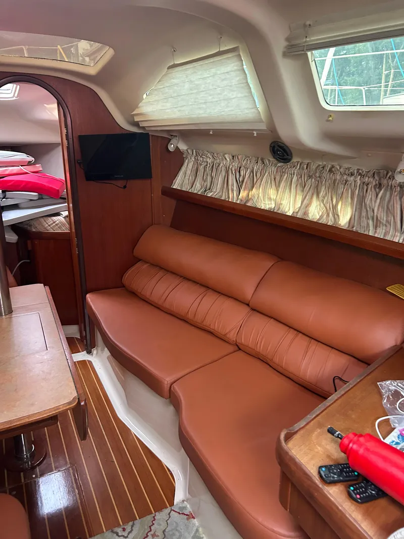 Slide: The Image of Interior of 1996 Hunter 336 sailboat with leather seating and wooden accents. - 31