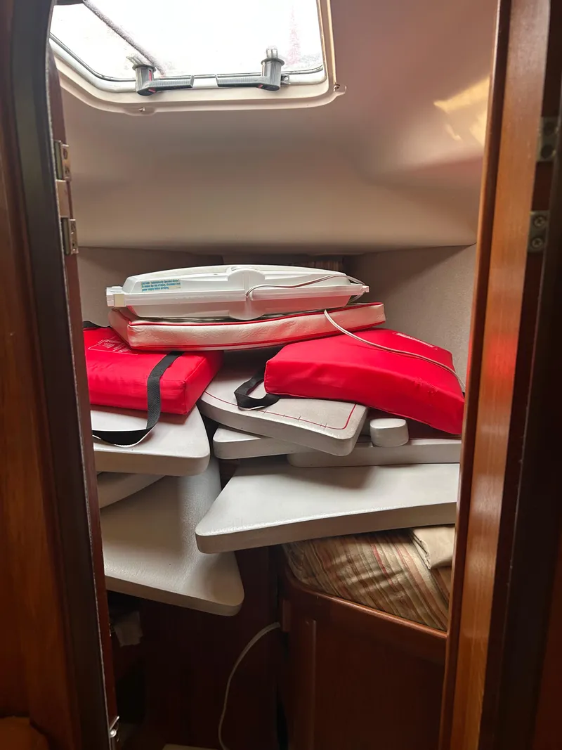 Slide: The Image of Interior of 1996 Hunter 336 sailboat with stacked cushions and life jackets. - 33