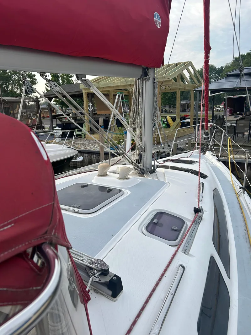Slide: The Image of Sailboat deck view of 1996 Hunter 336 with red sail cover at marina. - 6