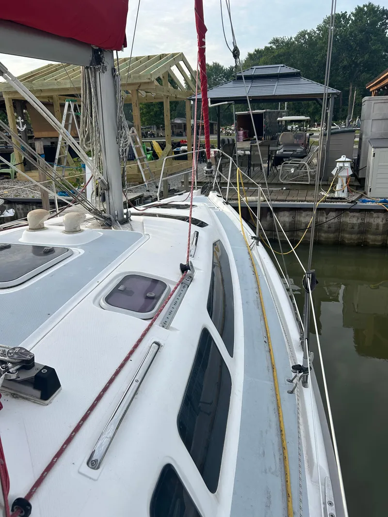 Slide: The Image of Sailboat docked at marina, Hunter 336 model, 1996, with visible rigging and deck details. - 7