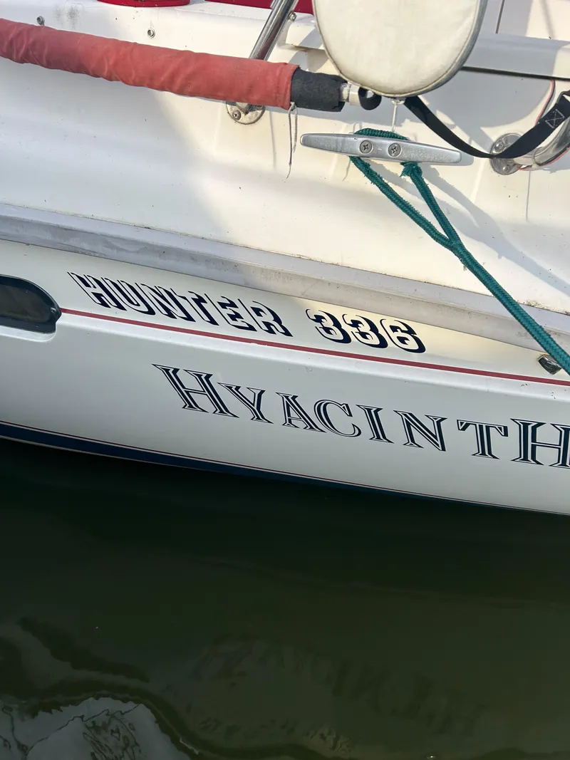 Slide: The Image of Sailboat "Hyacinth," Hunter 336, 1996 model, docked on calm water. - 8