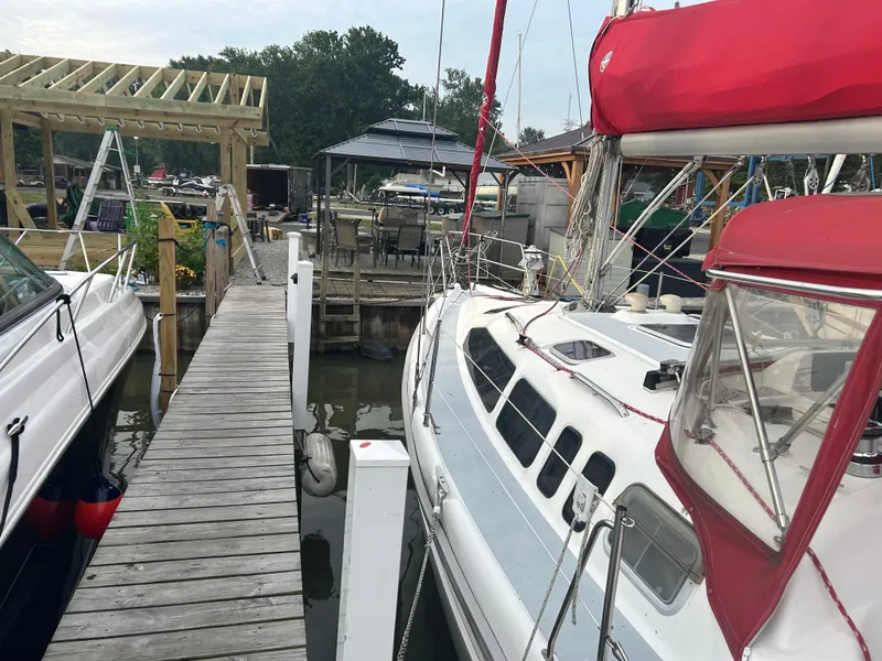 Slide: The Image of Sailboat docked at marina, Hunter 336 model, 1996, with red sail cover. - 9