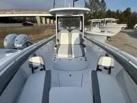 Slide: The Image of 2024 Everglades 315 Center Console boat with dual engines, docked near a bridge. - 12