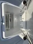 Slide: The Image of 2024 Everglades 315 Center Console storage compartment, spacious and well-designed for marine use. - 13