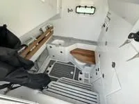 Slide: The Image of 2024 Everglades 315 Center Console cabin interior with seating and storage. - 15