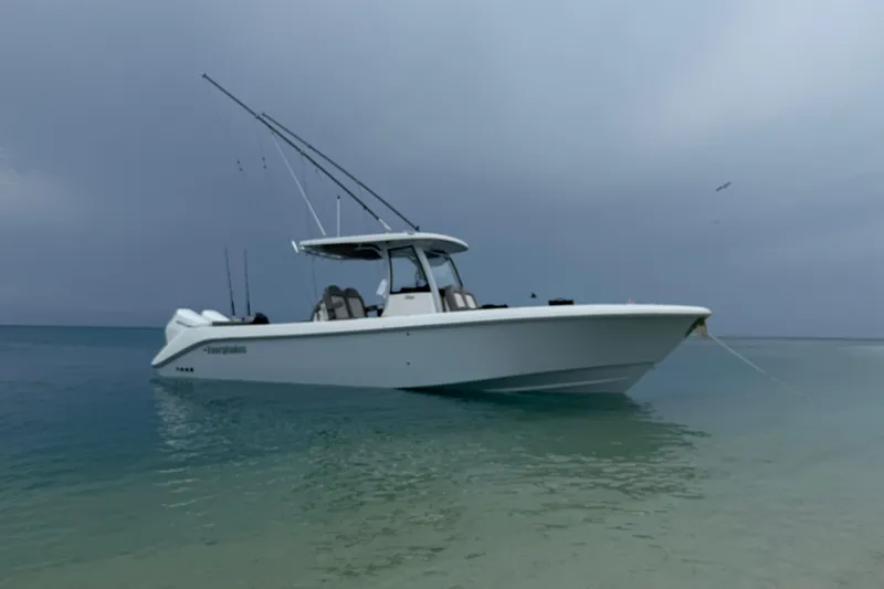 Slide: The Image of 2024 Everglades 315 Center Console boat anchored in calm, clear waters. - 20