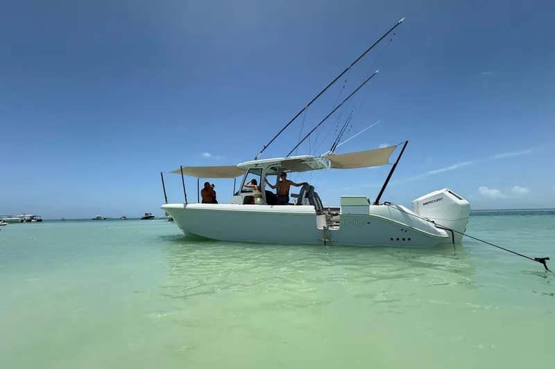 Slide: The Image of 2024 Everglades 315 Center Console boat in clear turquoise water under blue sky. - 22