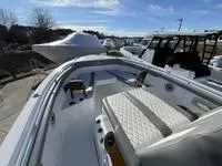 Slide: The Image of 2024 Everglades 315 Center Console boat with sleek design and spacious seating. - 8