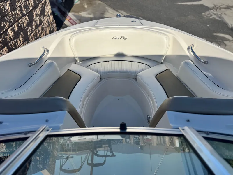 Slide: The Image of 2007 Sea Ray 210 Select boat interior with white seating and stainless steel handles. - 12