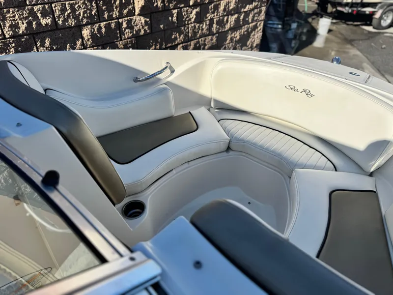 Slide: The Image of Interior seating of 2007 Sea Ray 210 Select boat with white and black upholstery. - 13