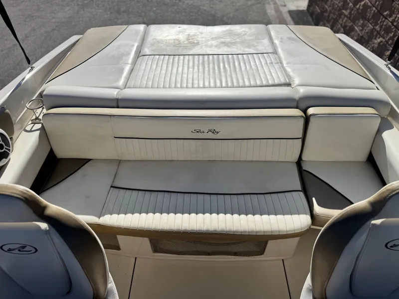 Slide: The Image of 2007 Sea Ray 210 Select boat interior with white leather seating and logo. - 16