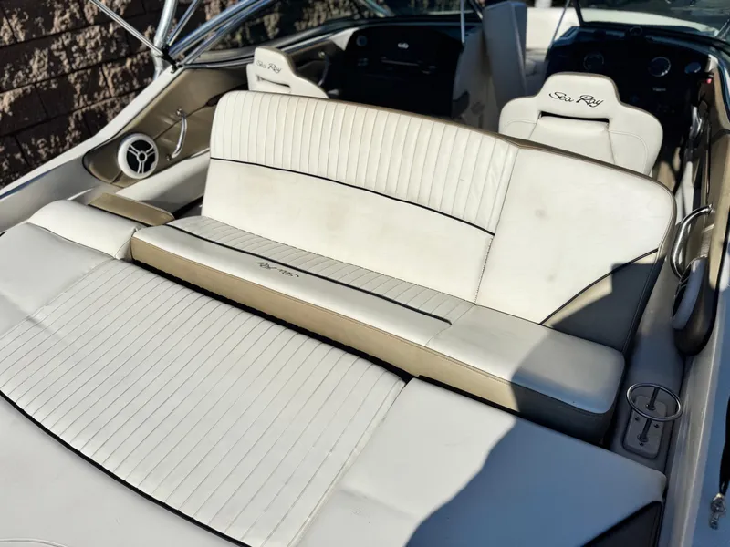 Slide: The Image of 2007 Sea Ray 210 Select boat interior with white seating and speaker detail. - 18