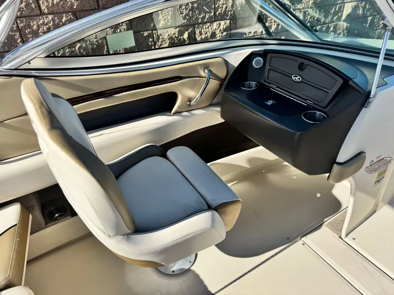 Slide: The Image of 2007 Sea Ray 210 Select boat interior with beige seating and dashboard. - 23