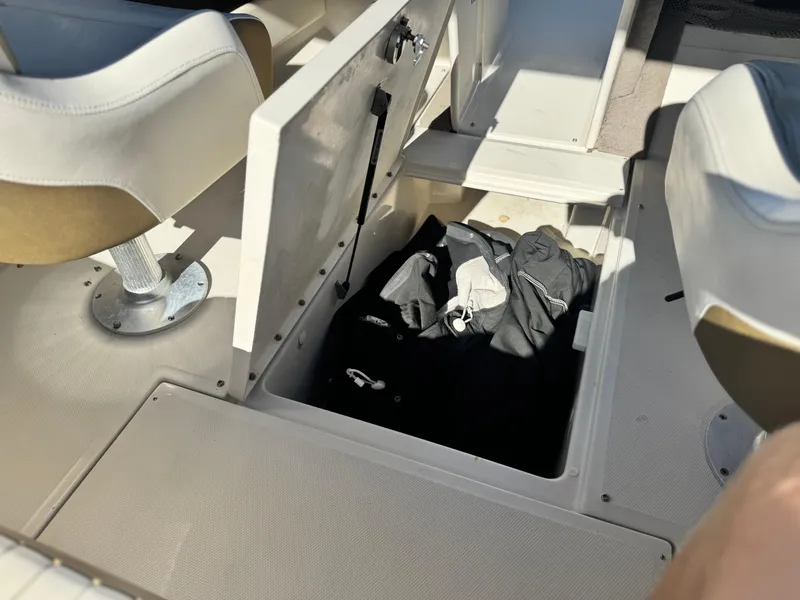 Slide: The Image of 2007 Sea Ray 210 Select boat interior with open storage compartment. - 25