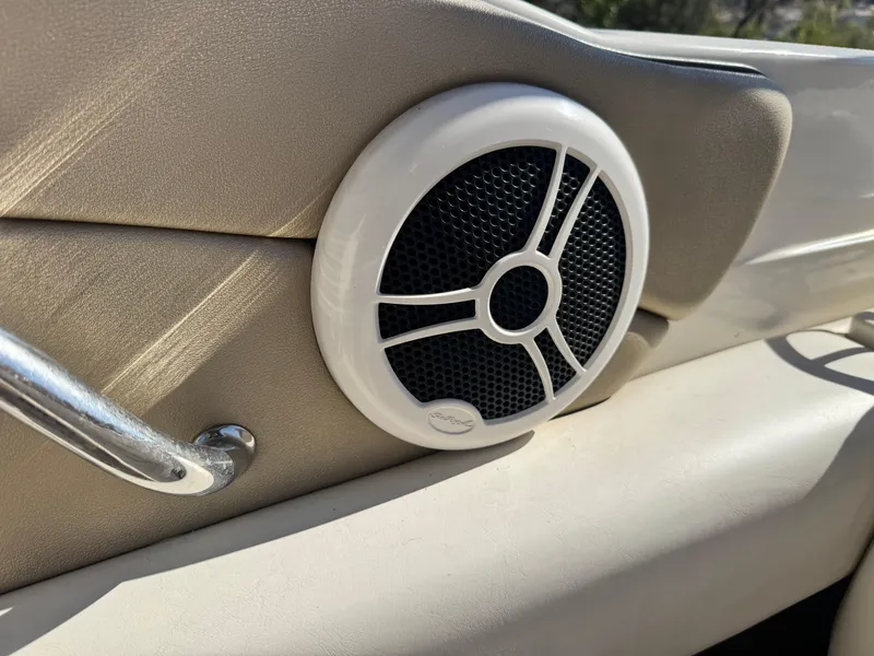 Slide: The Image of Speaker on 2007 Sea Ray 210 Select boat interior, featuring beige upholstery and chrome handle. - 26