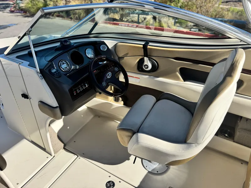 Slide: The Image of 2007 Sea Ray 210 Select boat interior with steering wheel and dashboard controls. - 27