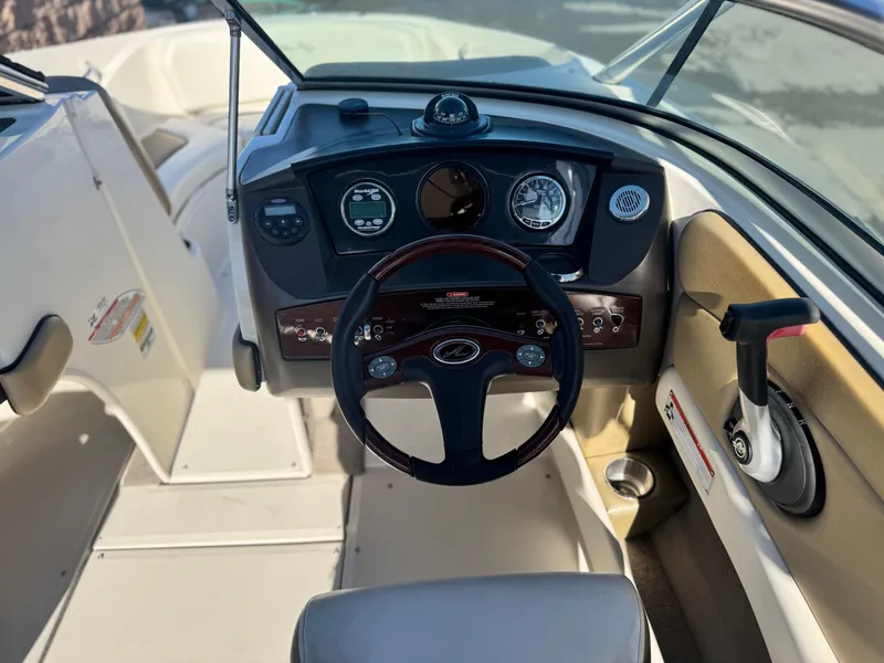 Slide: The Image of 2007 Sea Ray 210 Select boat dashboard with steering wheel and control panel. - 28
