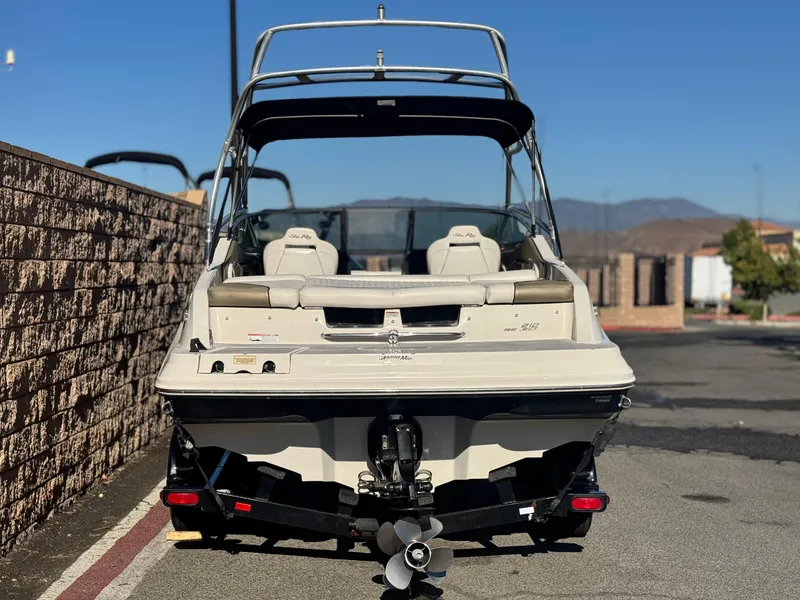 Slide: The Image of 2007 Sea Ray 210 Select boat, rear view, parked outdoors on a sunny day. - 4