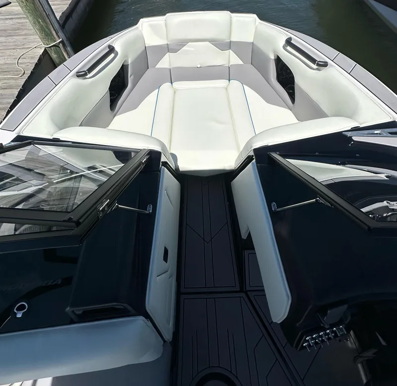 Slide: The Image of 2024 Moomba Mojo boat interior with white seating and sleek design. - 10