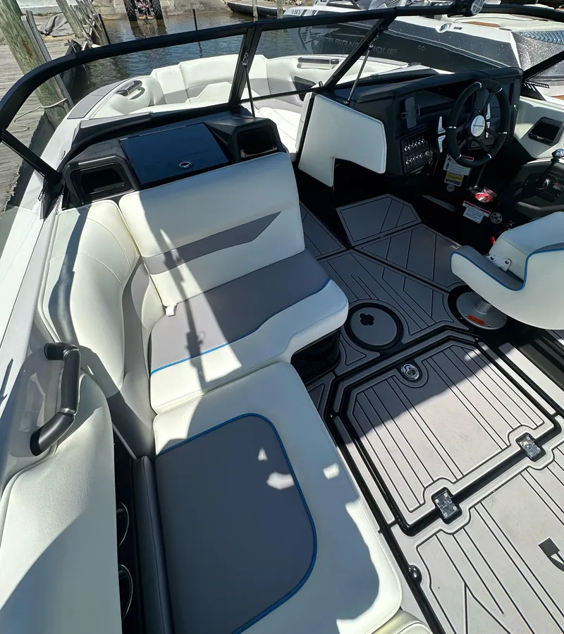 Slide: The Image of 2024 Moomba Mojo boat interior with sleek seating and modern dashboard design. - 7