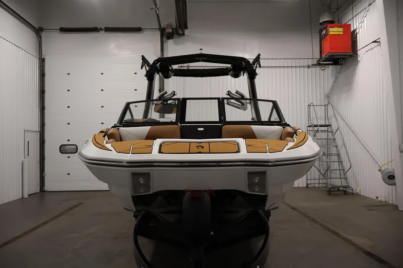 Slide: The Image of 2026 Centurion Fe22 boat in a garage, showcasing sleek design and modern features. - 1