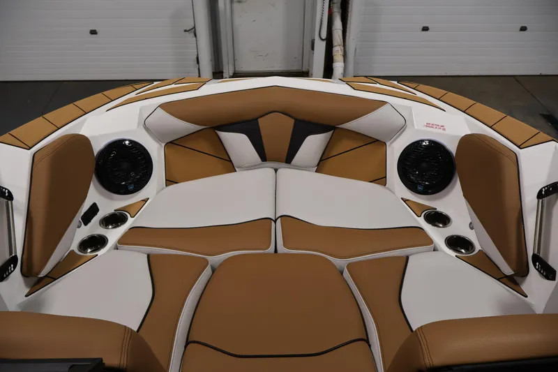 Slide: The Image of Interior of 2026 Centurion Fe22 boat with tan and white seating, cup holders, and speakers. - 10