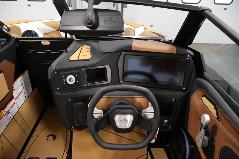 Slide: The Image of 2026 Centurion Fe22 boat dashboard with steering wheel and touchscreen display. - 13